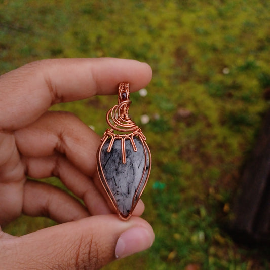 Tourmalinated quartz and ruby pendant